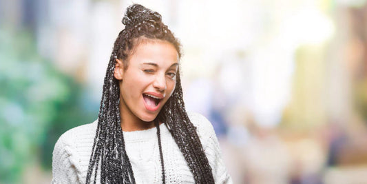A woman with braided hair, which is one of the best winter protective hairstyles.
