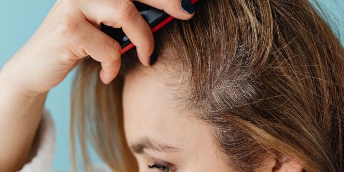 A lady brushing her oily scalp.
