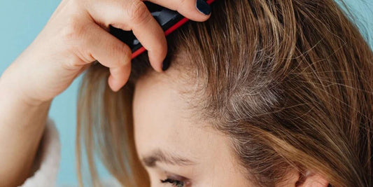 A lady brushing her oily scalp.