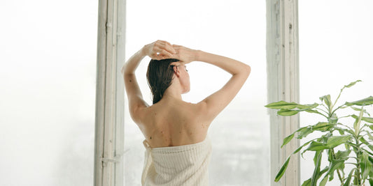 A female caring for her fine hair.