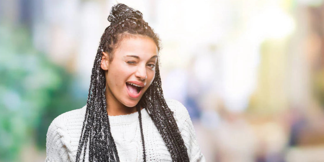 A woman with braided hair, which is one of the best winter protective hairstyles.
