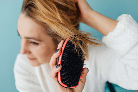 A female caring for her fine hair.