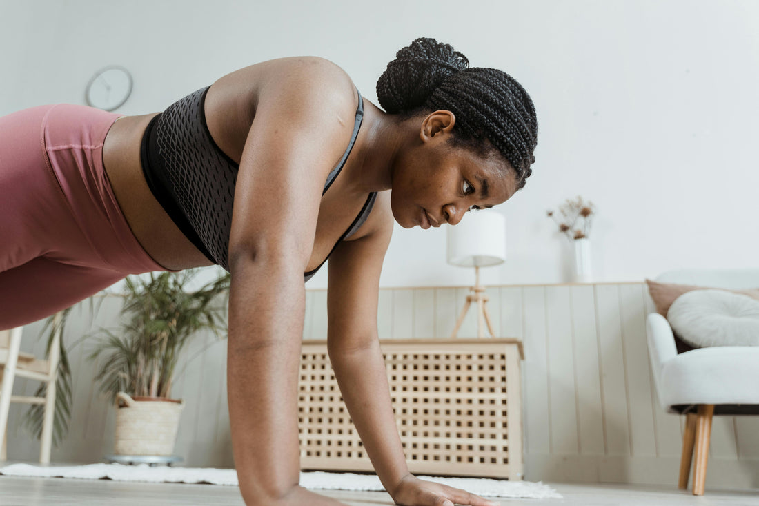 A woman working out with braids.