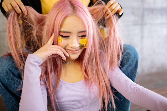  Young woman with long freshly-colored pastel pink hair.