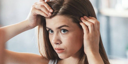 woman checking for hair loss symptoms